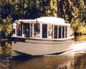 A Bolger designed power sharpie Champlain, a beautiful example of this 22 foot river cruiser built by Han Van Pelt. This owner and boat have committed to attend.